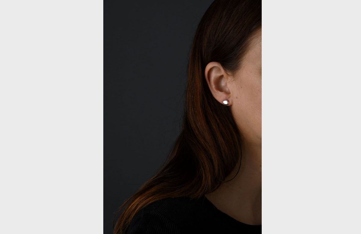 Woman Wearing Pebble Stud Earrings