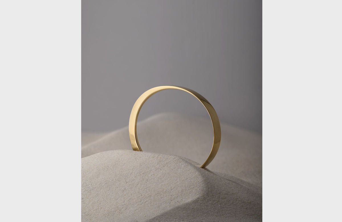 Round Bronze Bangle Styled in Sand