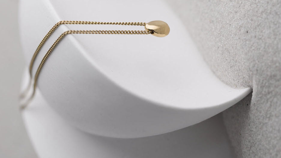 Solid Gold Necklace Draped on a Sculpture