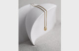 Solid Gold Necklace Draped on a Sculpture